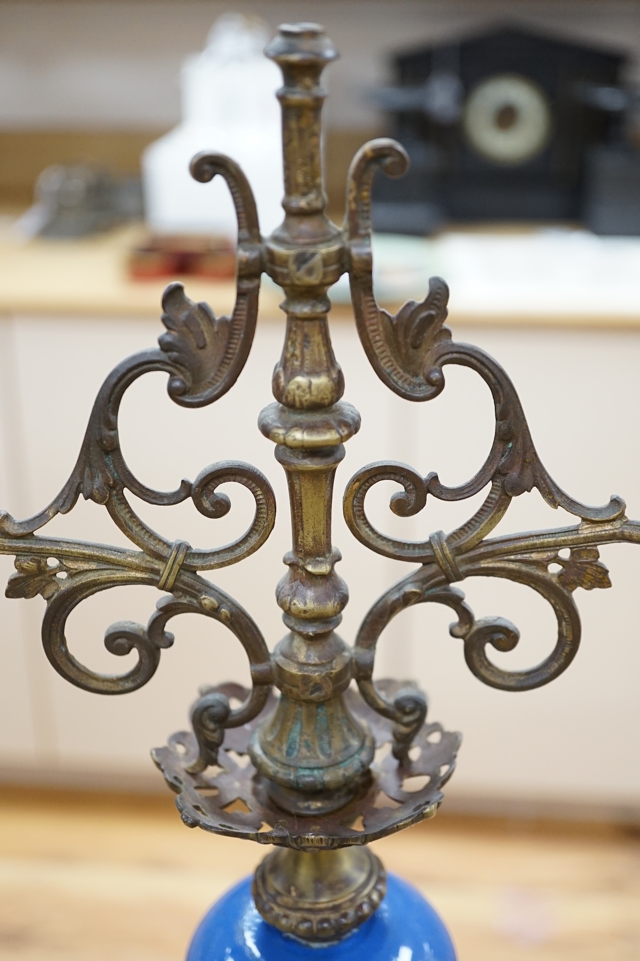 A pair of French blue enamelled ornate brass two branch candlesticks, 42cm high. Condition - one finial missing, scratches to enamel